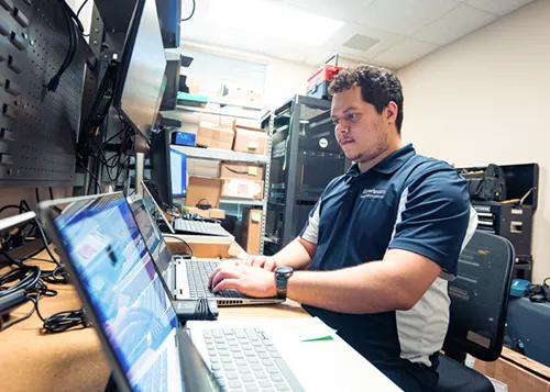 MITS tech working on a computer
