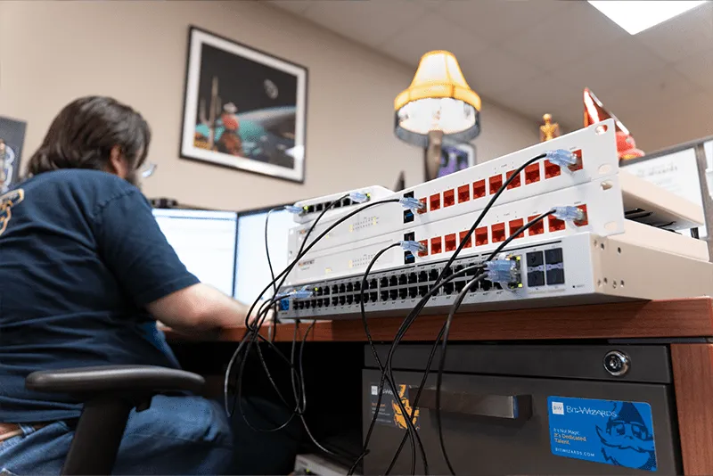 MITS tech working on a computer